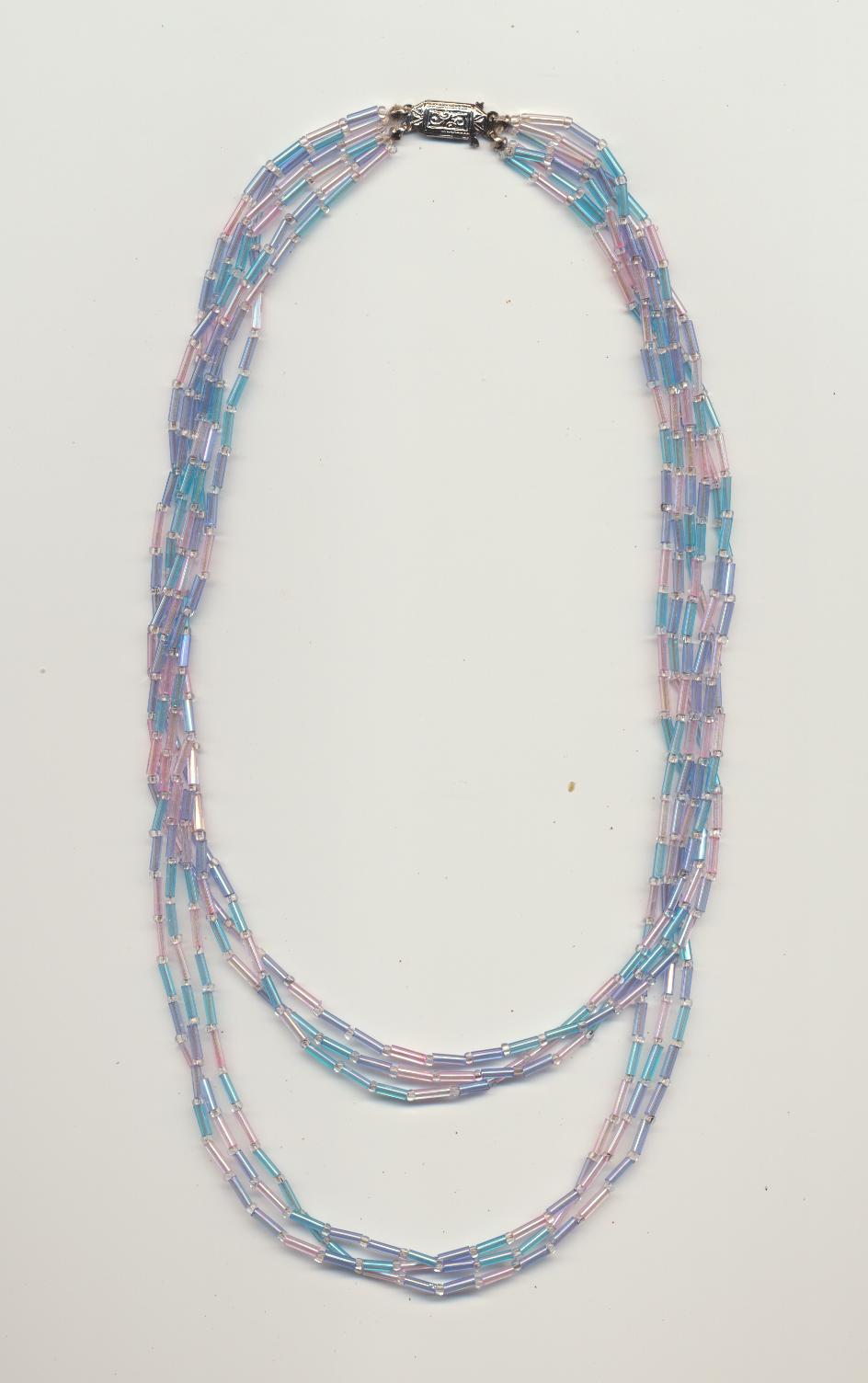 A Twisted Bead Necklace Made Of Strands Of Uneven Length