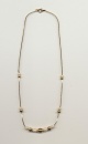 Modest necklace of gold color beads and imitation pearls on gold color chain, made in Korea, length 24'' 60cm.